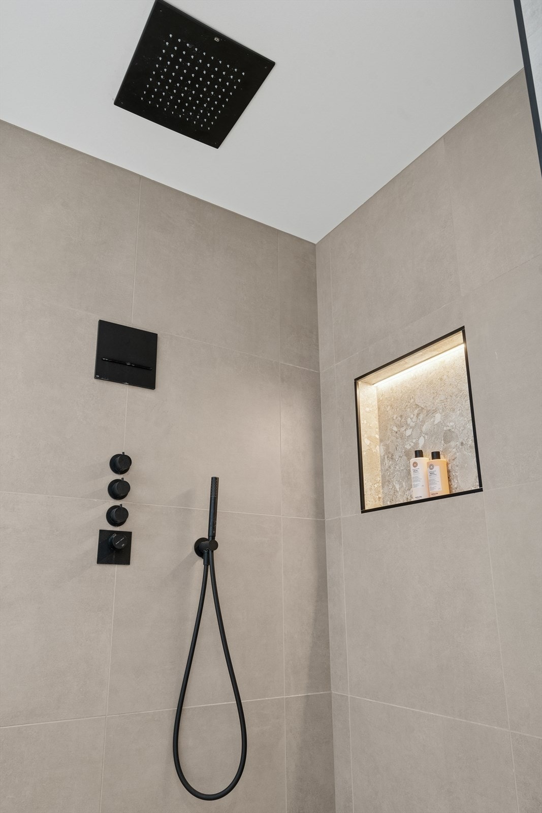 Dusjnisjen har bl.a. integrert armatur, regnfallsdusj og integrert vegghylle m/belysning Galleribilde