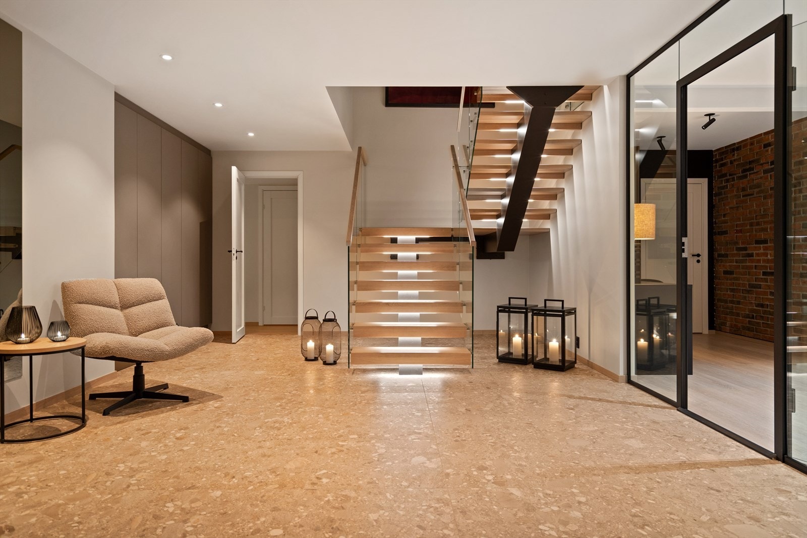 Trappen opp til hovedetasjen er utført med "svevende" trappetrinn m/integrert belysning og rekkverk i glass Galleribilde