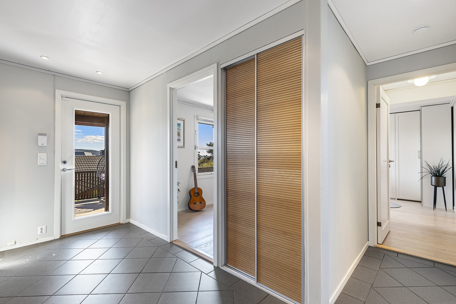 Velkommen inn! Entrèen er flislagt med gulvvarme. Det er god plass til yttertøy og sko i skyvedørsgarderobe og skapplass. Galleribilde