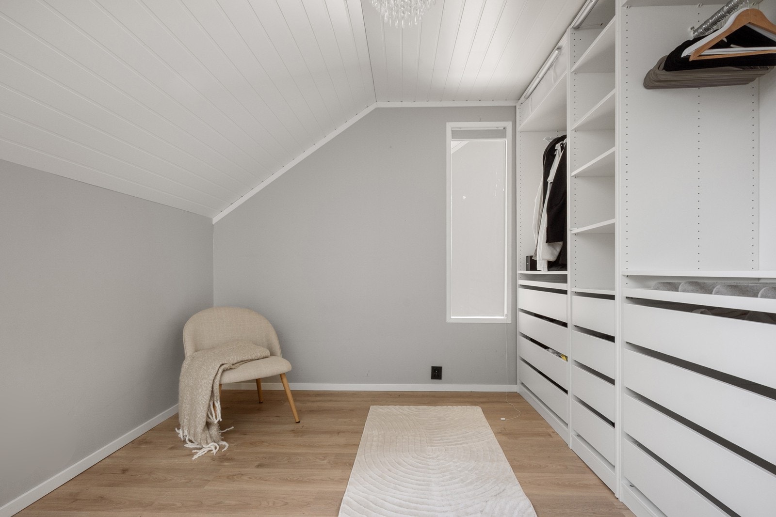 Det siste soverommet er brukt som walk-in garderobe med garderobeinnredning på en hel vegg. Galleribilde