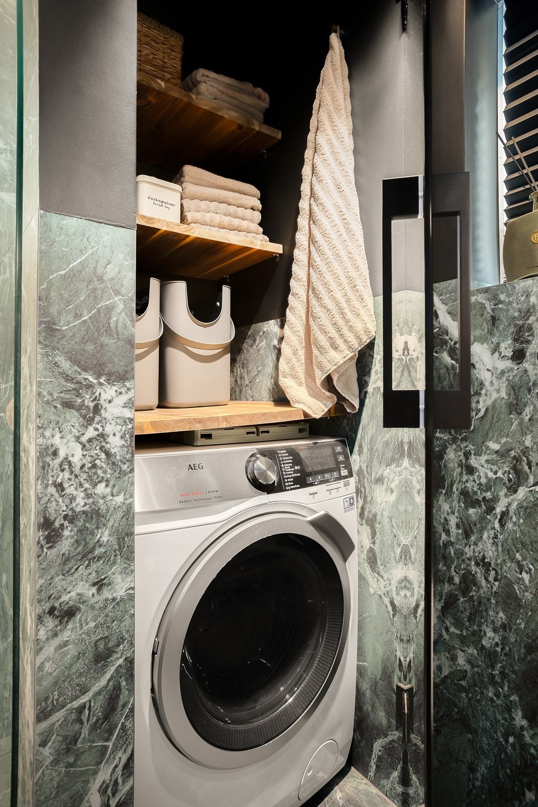 Vaskesonen er elegant integrert bak skapdør og byr på smarte oppbevaringsløsninger. Galleribilde