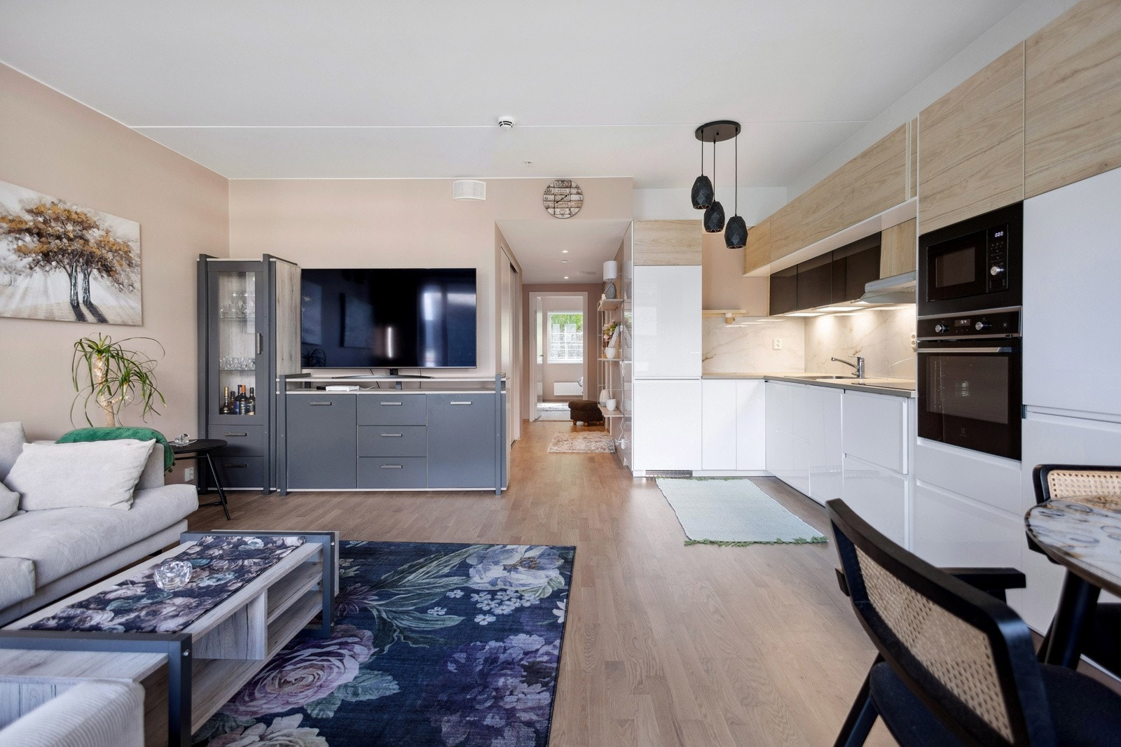 Åpen stue-kjøkken løsning som åpner rommet og gjør det til et sosialt allrom. Galleribilde