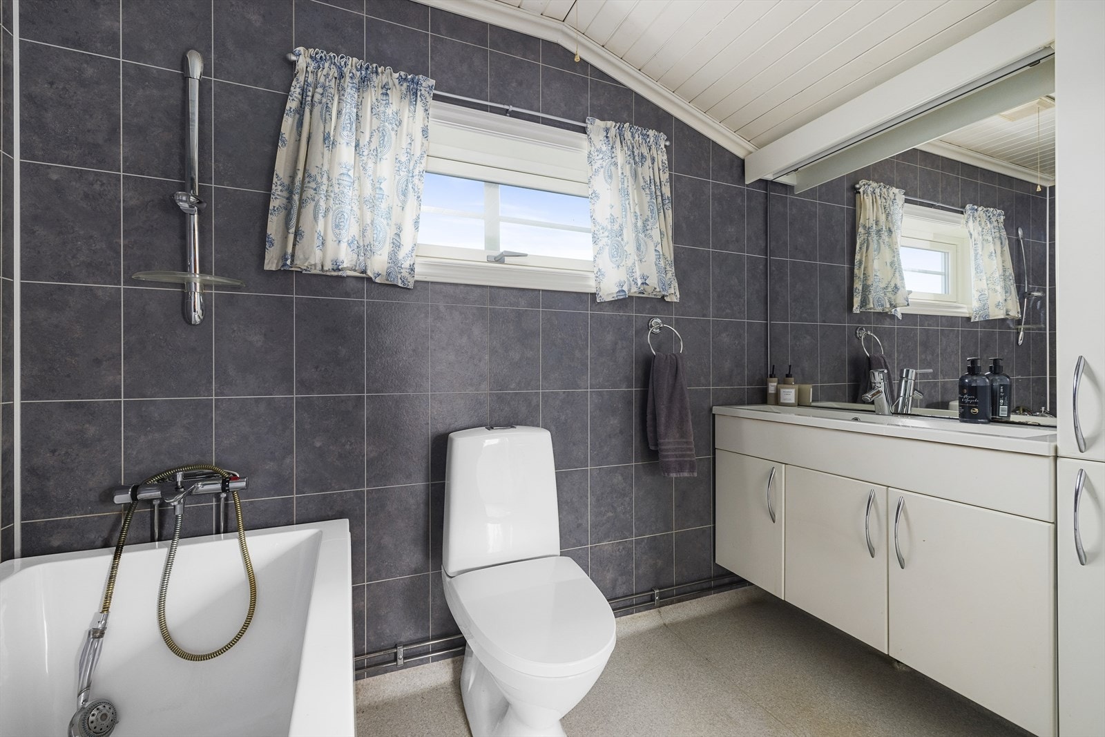 Bad med toalett og opplegg for vaskemaskin Galleribilde