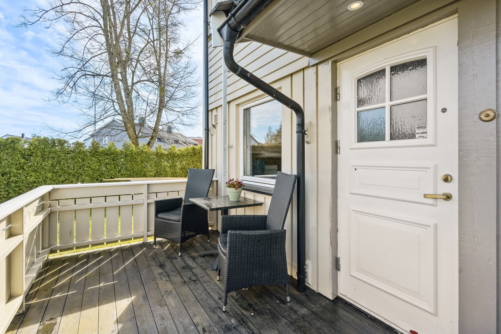 Hyggelig inngangsparti med veranda og fint utsyn til store fellesarealer med plen og lekeplass. Galleribilde