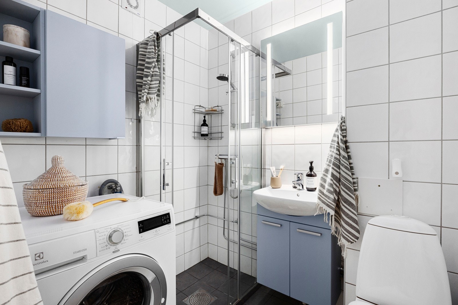 Flislagt bad med varmekabler. Nye varmekabler, fliser på gulv og dusjdører i 2021, speilskap fra 2024. Galleribilde