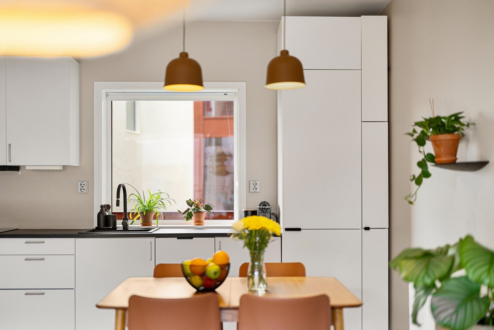 Kjøkkenet er levert av Sigdal og har hvite, stilrene skapfronter og benkeplate i laminat. Galleribilde