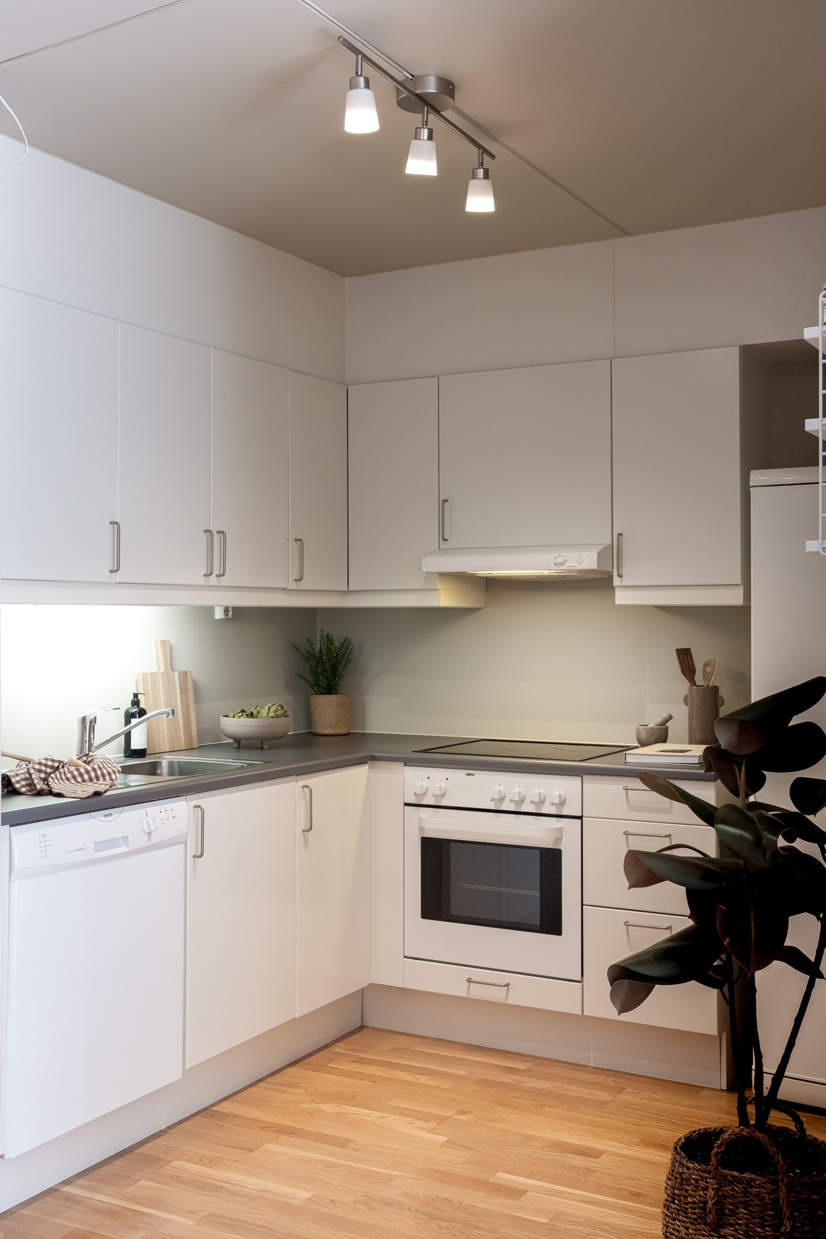 Kjøkkeninnredningen består av lyse, slette fronter med benkeplate i laminat og nedfelt oppvaskkum med ett-greps armatur. Galleribilde