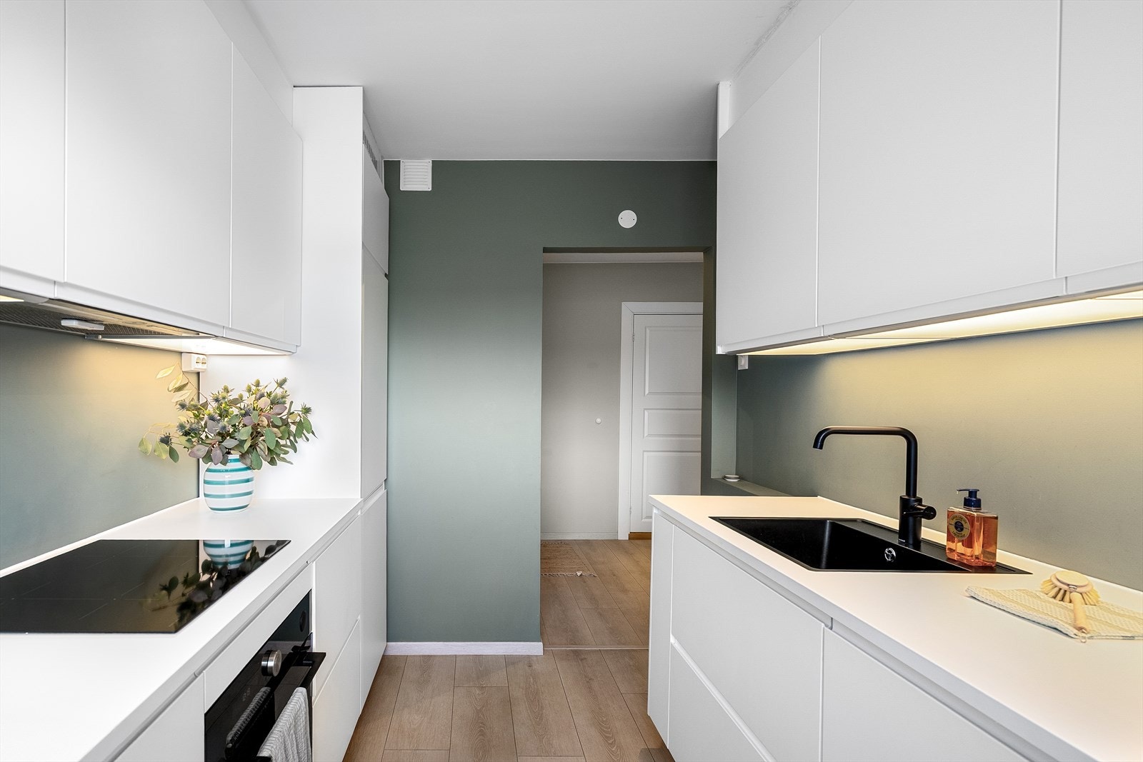 Innredningen strekker seg over to flater med både over- og underskap på begge sider. Dette gir ekstra plass til både matlaging og oppbevaring. Galleribilde