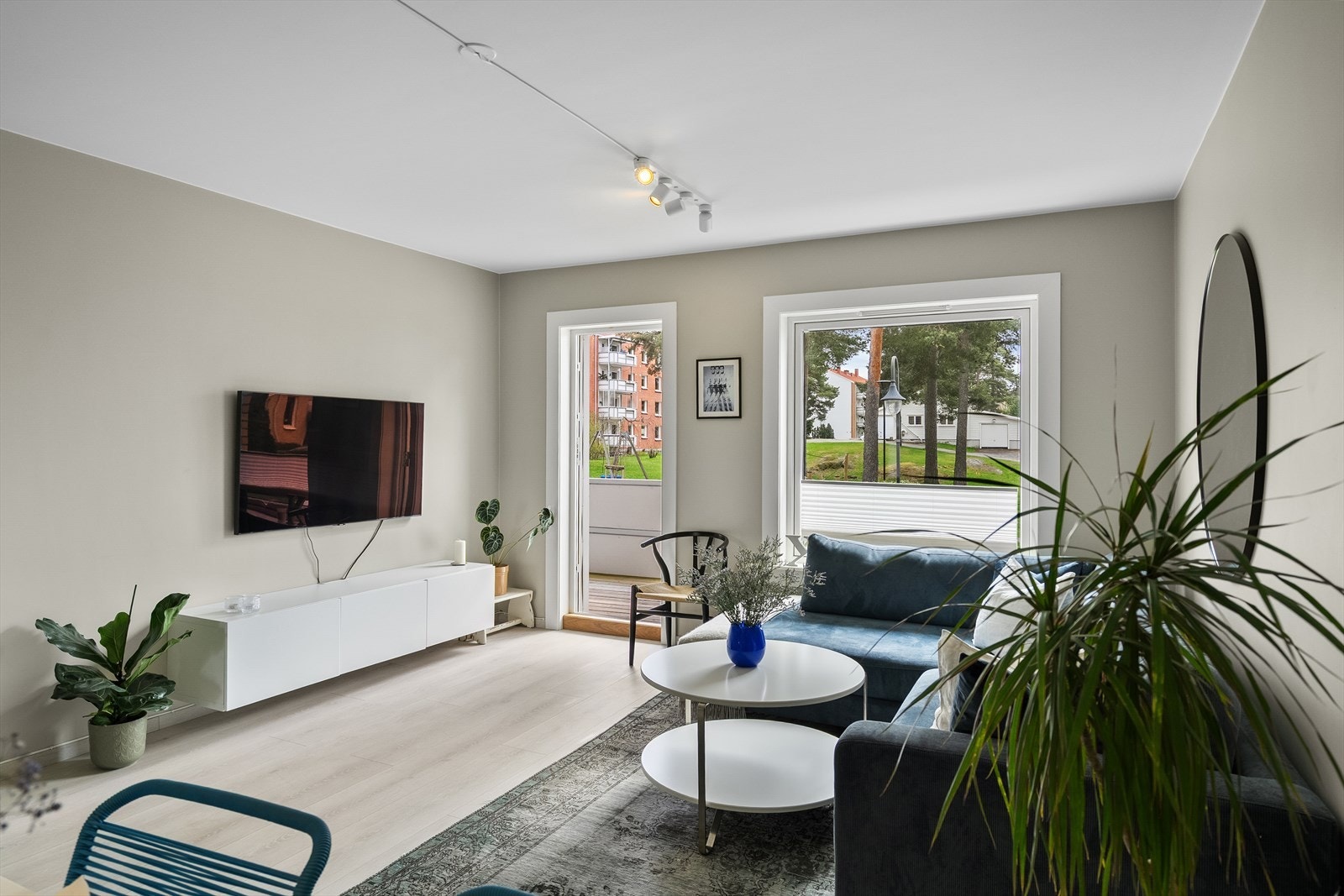 Stuen fremstår som lys og innbydende, med en moderne fargepalett i tidsriktige nyanser på både gulv og vegger. Galleribilde