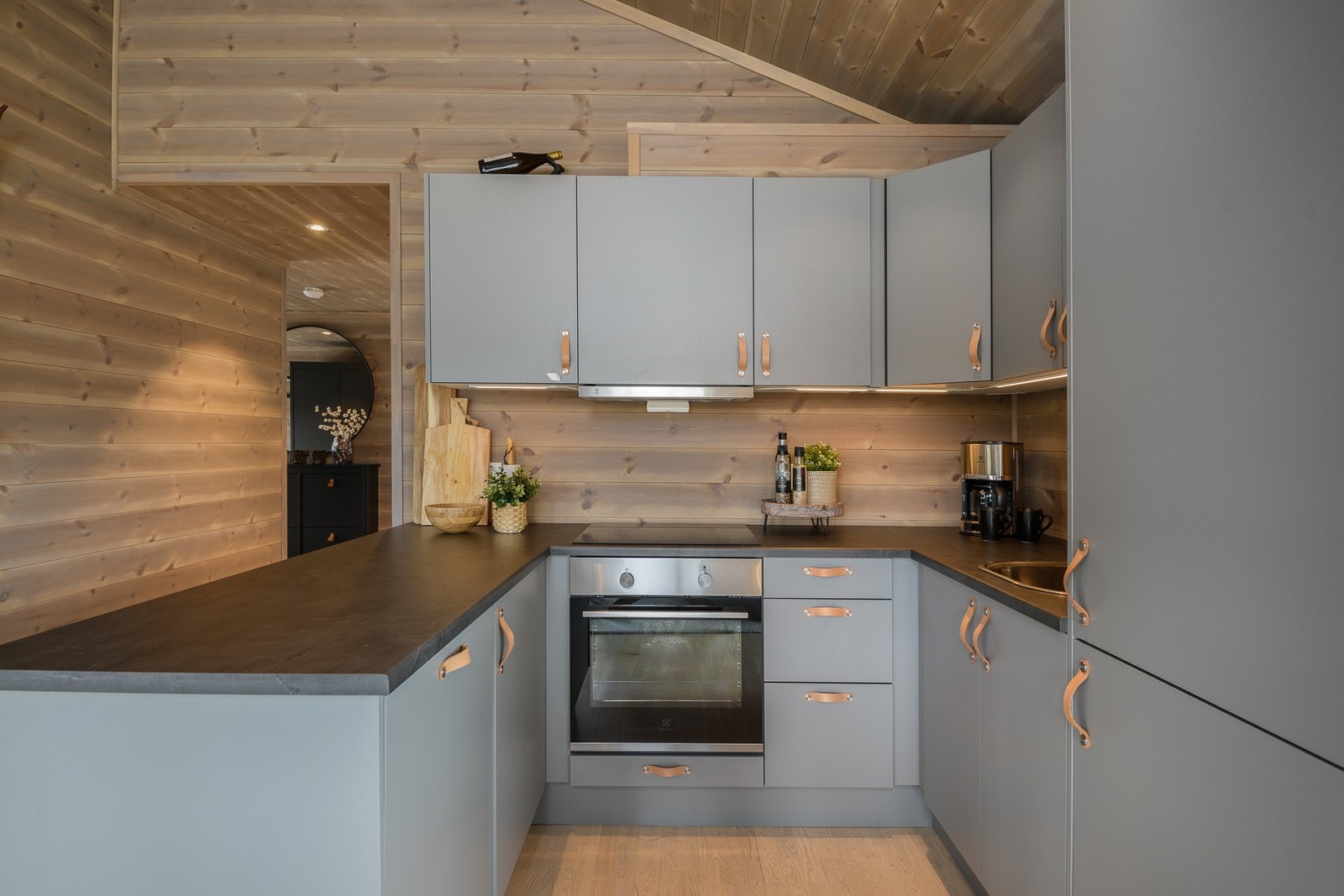 Kjøkkenet har en smakfull innredning med glatte fronter og laminerte skrog. Galleribilde