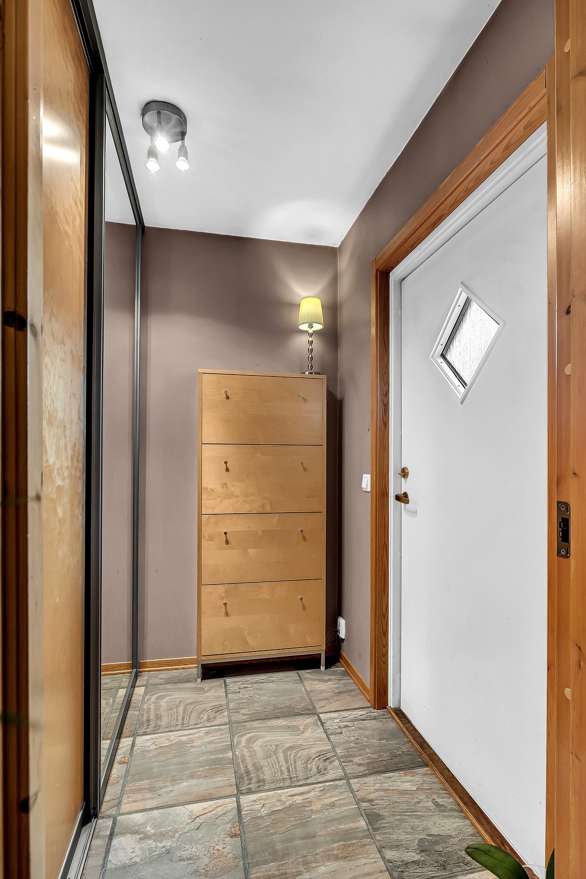 Velkommen inn i entréen hvor det er skyvedørsgarderobe for oppbevaring av yttertøy og sko. Her er det belegg på gulvet, slette malte vegger og himling. Galleribilde