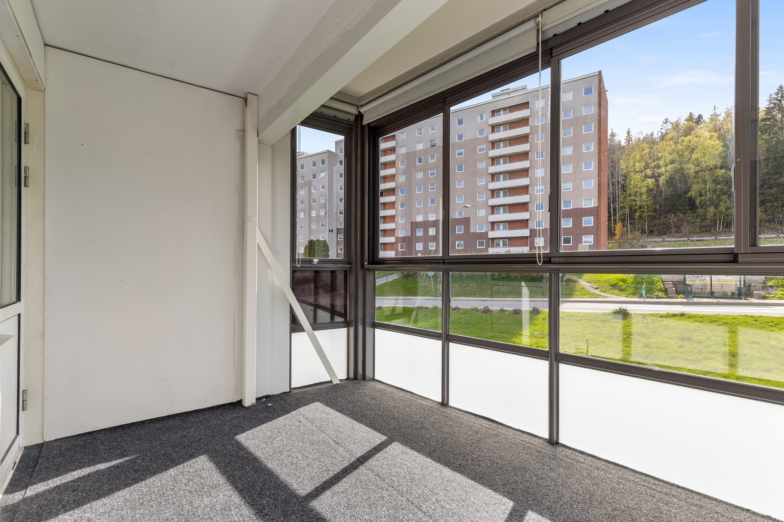 Gulvoverflater er belagt med teppe og rekkverket består av metall og glass med skyvbare glassfelter Galleribilde