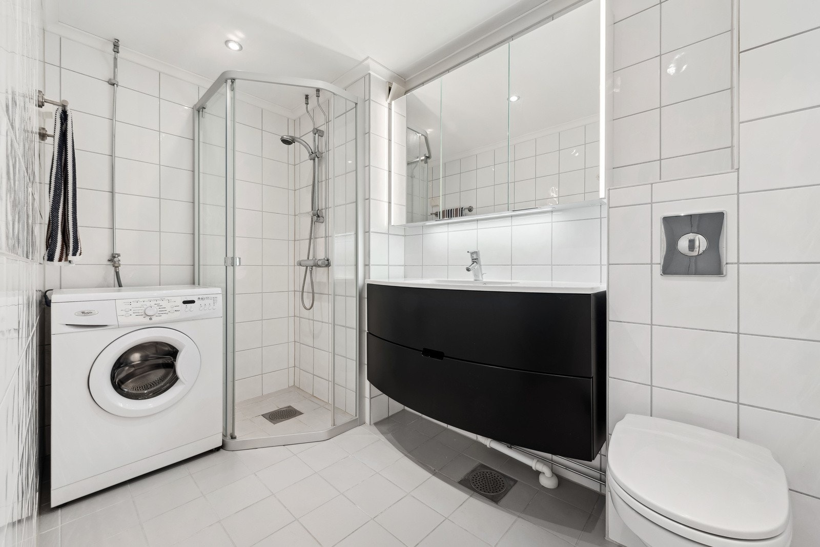 Utvidet, flislagt baderom med gulvvarme og opplegg for vaskemaskin. Galleribilde