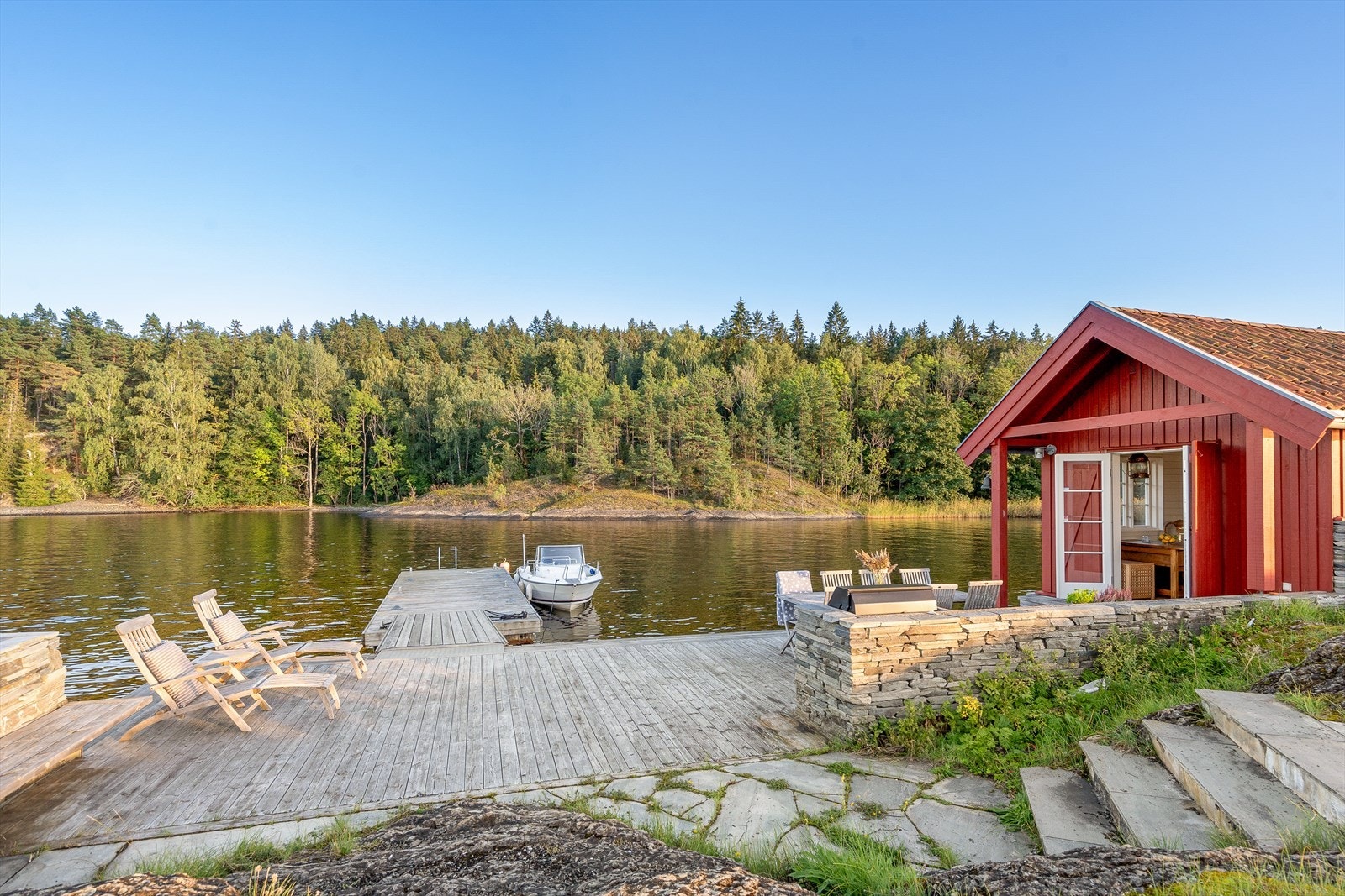 Fantastisk båtnaust med tilhørende brygge. Denne utmerkede fasiliteten gir enkel tilgang til vannet og er ideell for båtelskere som ønsker å utforske fjorden eller bare nyte vannaktiviteter. Galleribilde