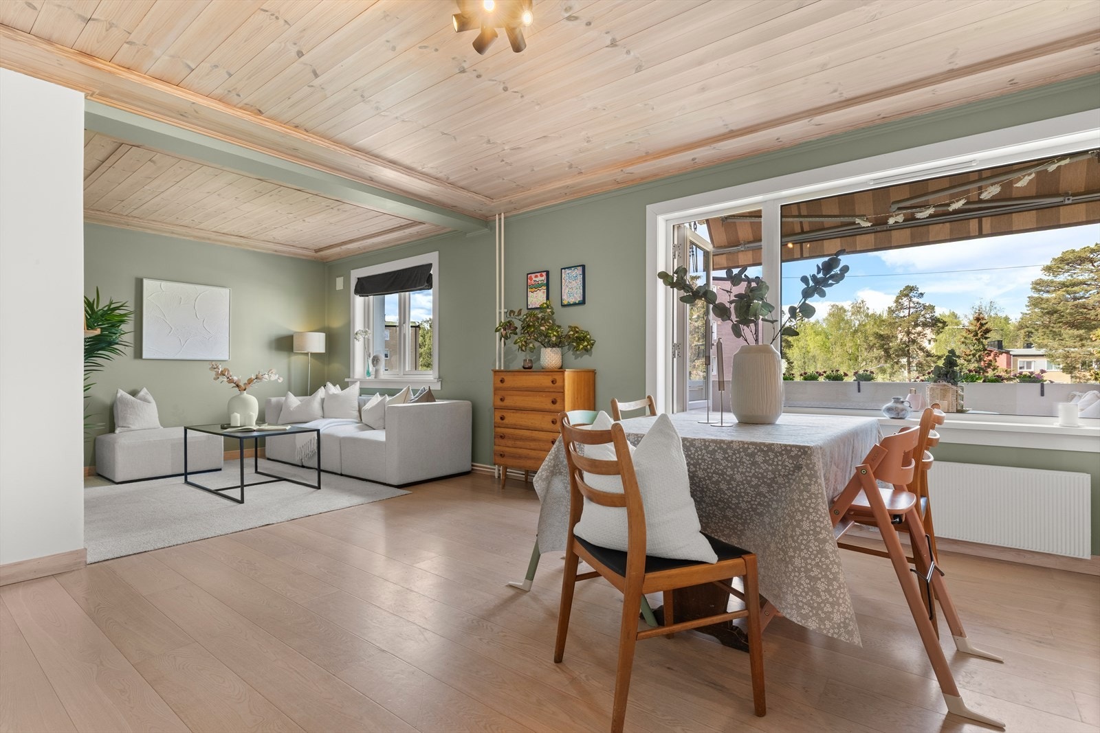 Stort oppholdsrom med fine soneinndelinger, store vindusflater og usjenert utsyn over grønne omgivelser med mye luft mellom blokkene. Galleribilde