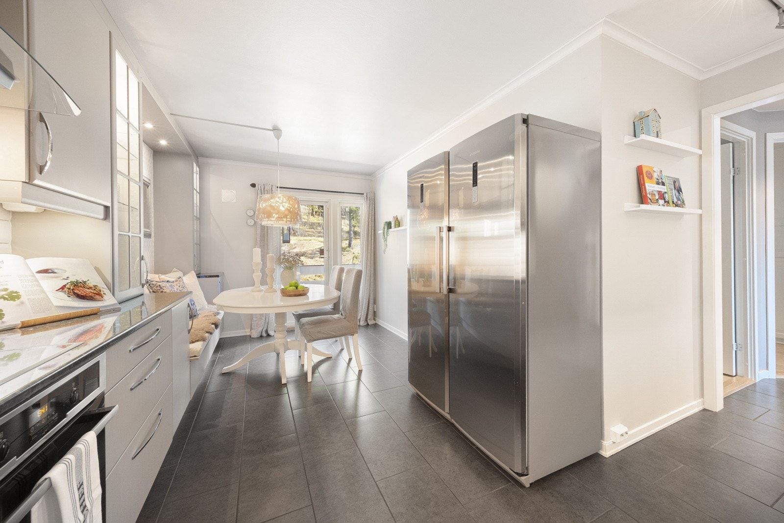 Kjøkkenet har en L-formet innredning fra 2013 med takhøye skap og spiseplass i egen sone. Galleribilde