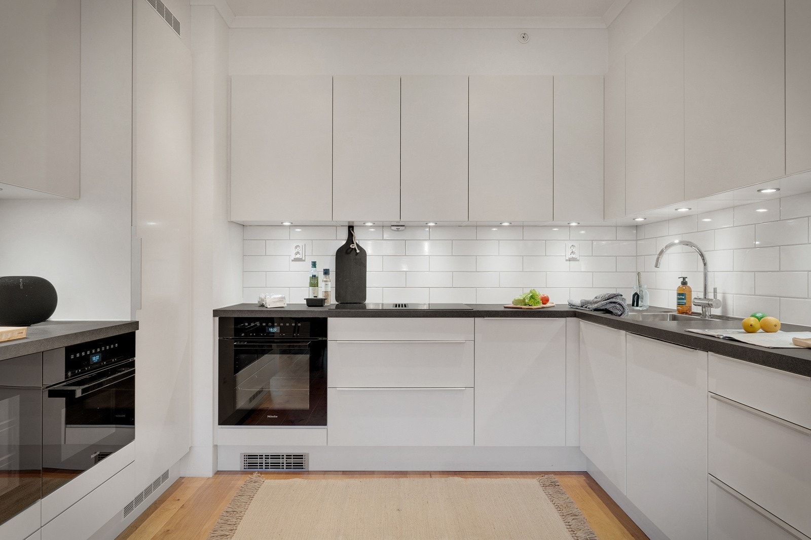 Kjøkkenet med tidsriktige slette fronter og lekker benkeplate. Galleribilde