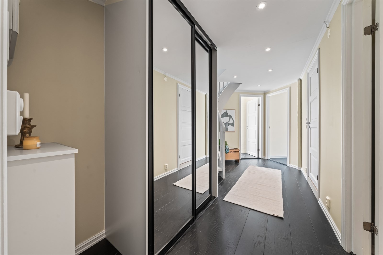 Entré/gang med plassbygget skyvedørsgarderobe (2021) og nye downlights (2025). Galleribilde