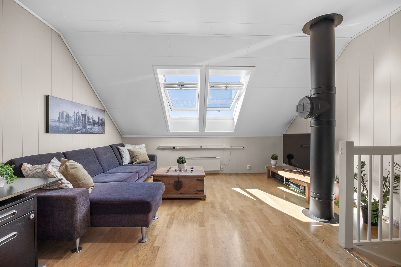 I tredje etasje er det en romslig loftstue med luftig atmosfære Galleribilde