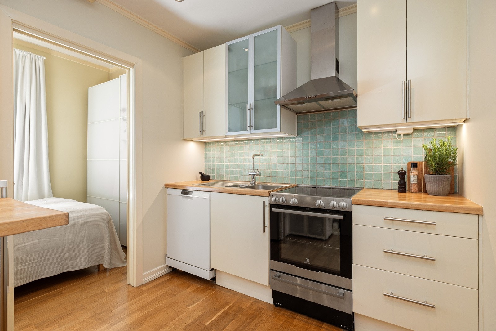 Flislagt mellom over- og underskap, benkeskapsbelysning under overskap med stikkontakt. Galleribilde