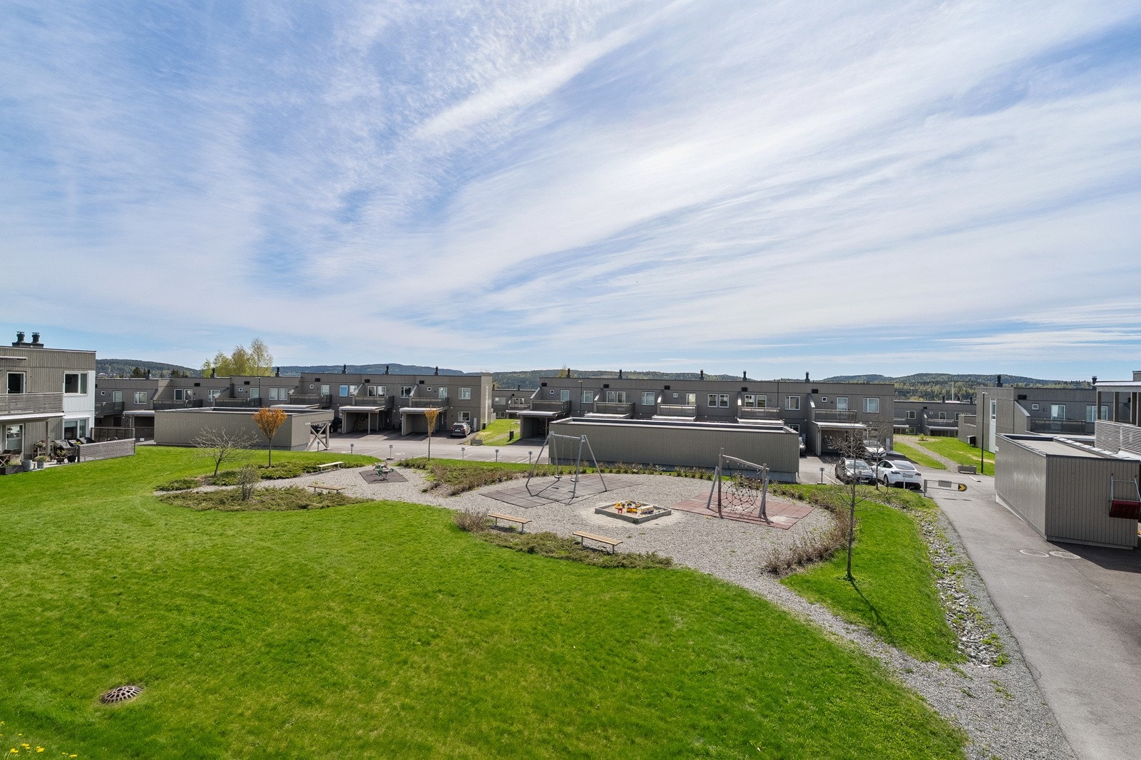 Rett utenfor leiligheten er det flott lekeplass og grøntområde. Her kan barna leke trygt, mens mamma og pappa følger med fra balkongen. Galleribilde