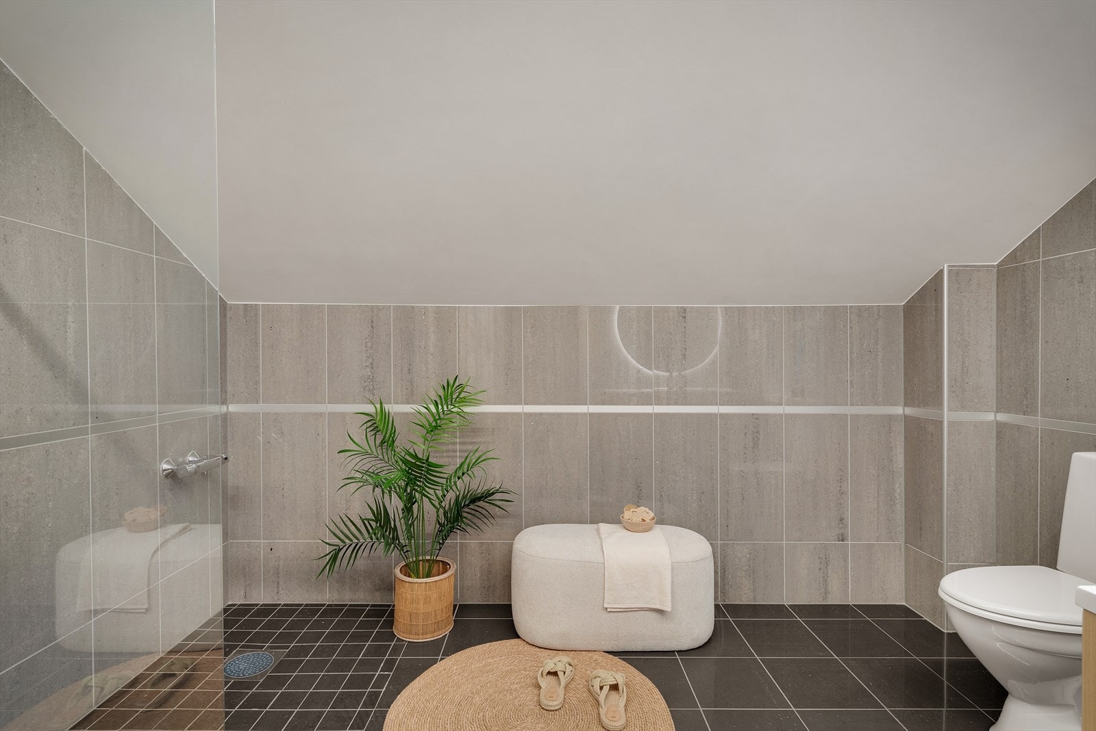 - Innredet med gulvmontert toalett, benkeskap med servant, speil med integrert belysning og dusjhjørne med glassvegger - Galleribilde