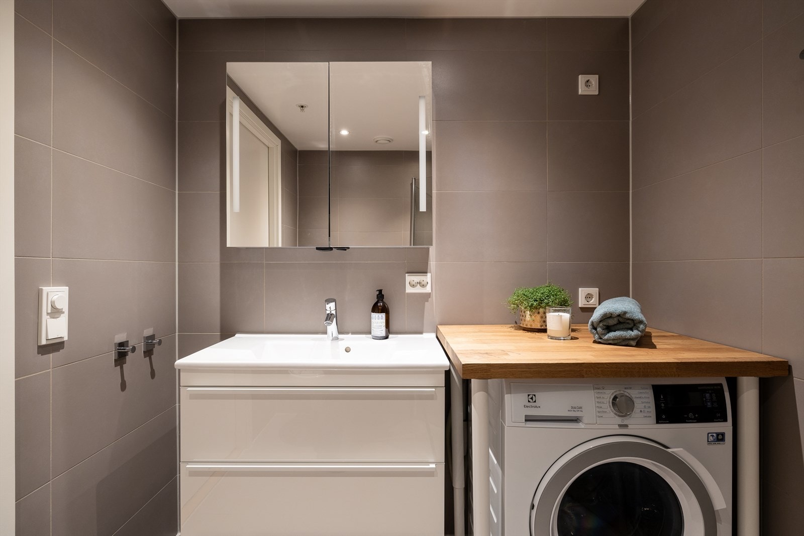 Baderommet har gulvvarme og downlights i taket som gir en hyggelig atmosfære under morgen- og kveldstellet. Det er i tillegg opplegg for vaskemaskin og tørketrommel på baderommet. Galleribilde