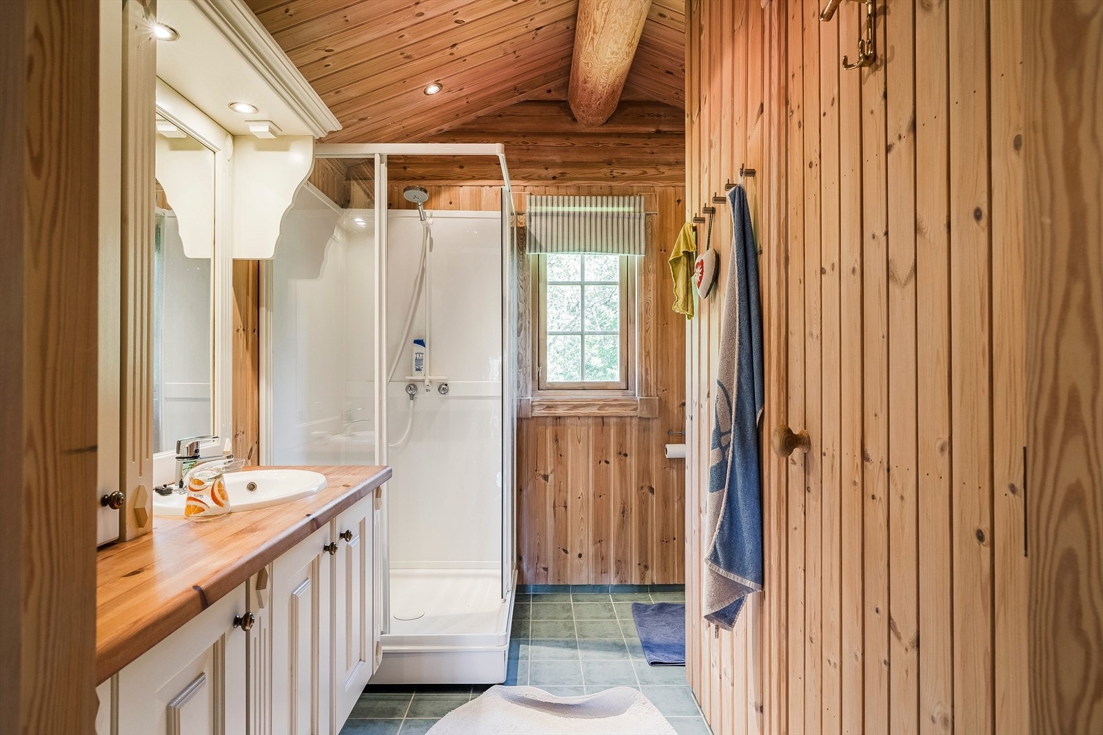 I likhet med første etasje, har andre etasje også et baderom. Rommet har flislagt gulv med varmekabler, og er innredet med servant nedfelt i romslig innredning med overskap, belyst speil, dusjkabinett og frittstående toalett. Galleribilde