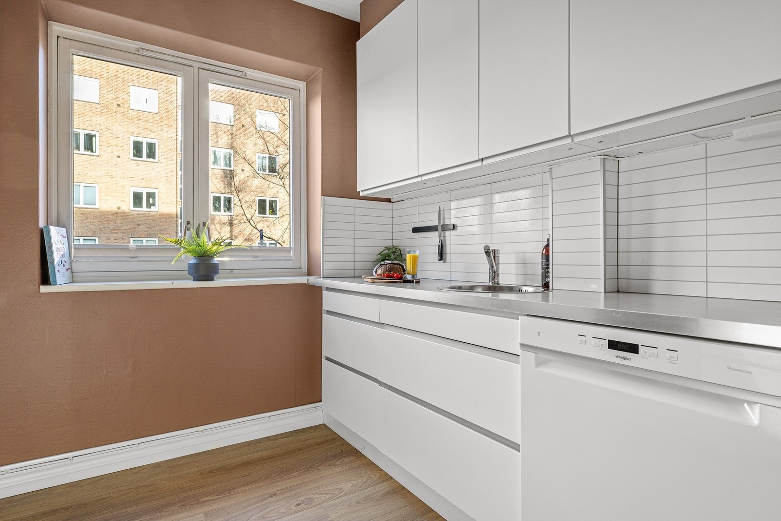 Kjøkkeninnredning med glatte fronter og foliert benkeplate med nedfelt oppvaskkum Galleribilde