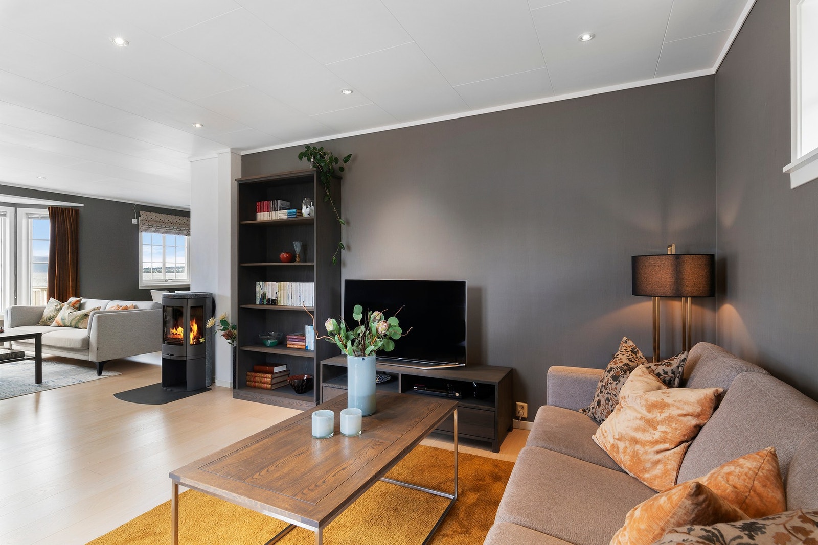 Vinkelstue som innbyr til lun og koselig tv-krok, i tillegg til plass for møbelgruppe og spisestuemøbler. Galleribilde