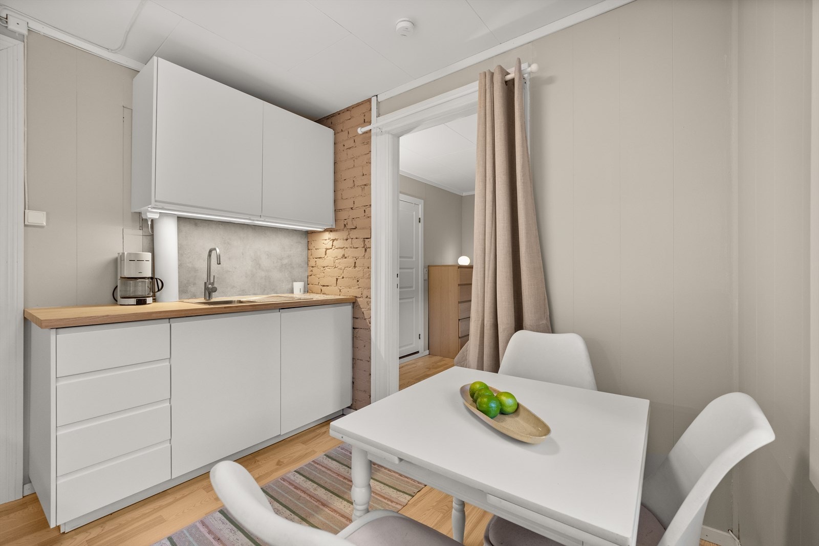 Kjøkkenet er utstyrt med integrerte hvitevarer som kjøleskap, stekeovn og platetopp Galleribilde