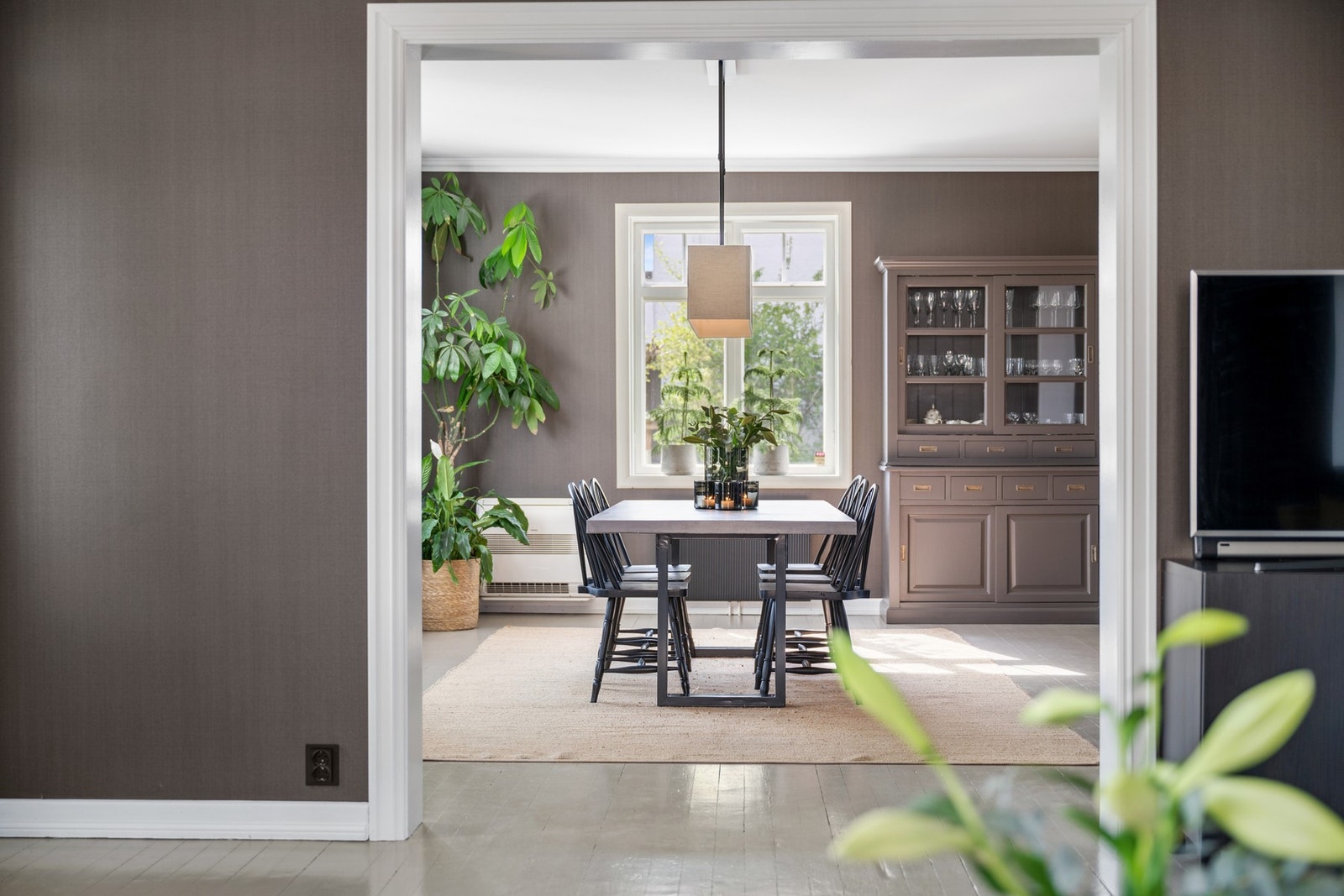 Sentralt plassert mellom stue og kjøkken - spisestuen binder sonene sammen på en naturlig og stilfull måte. Galleribilde