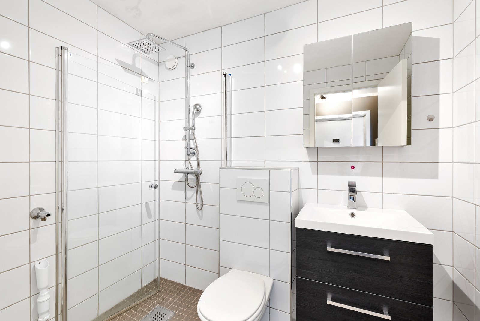 Helfliset bad med vegghengt klosett og innfellbart dusjhjørne. Galleribilde