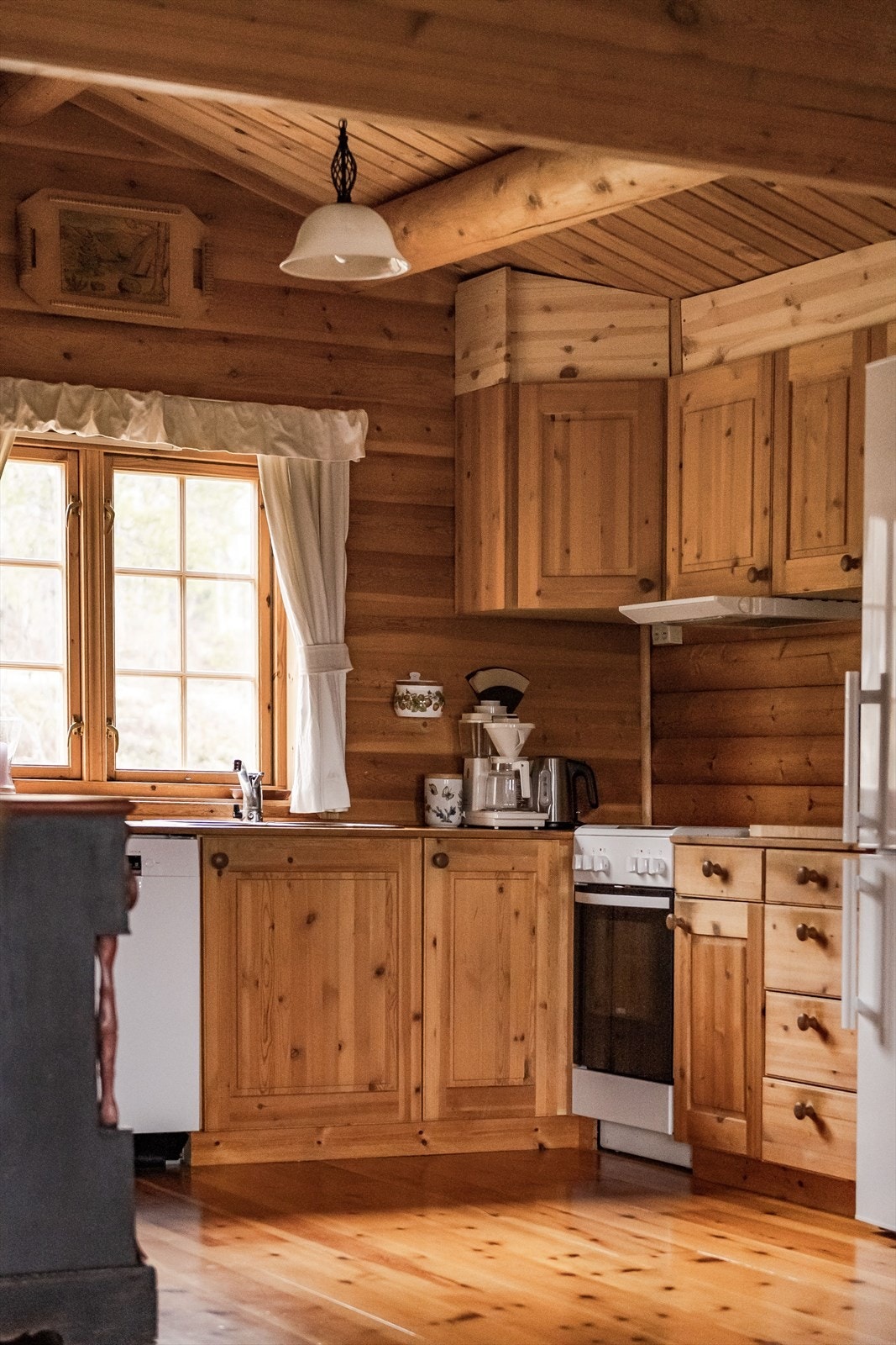 Heltre kjøkkeninnredning med god skap- og benkeplass. Innredningen har profilerte fronter og benkeplate i tre med nedfelt oppvaskkum. Ventilator med mekanisk avtrekksvifte. Galleribilde