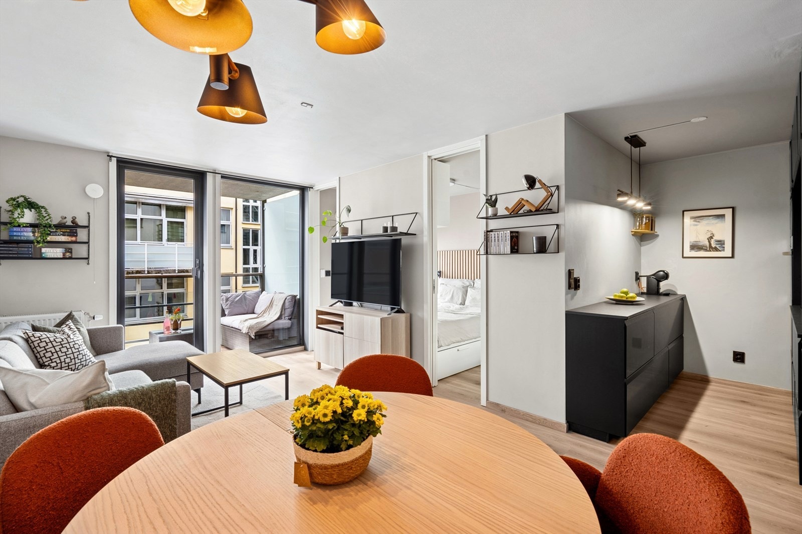 Lys og romslig stue med direkte adkomst til soverom på begge sider av sengen, samt utgang til balkong og tilgang til kjøkken. Galleribilde