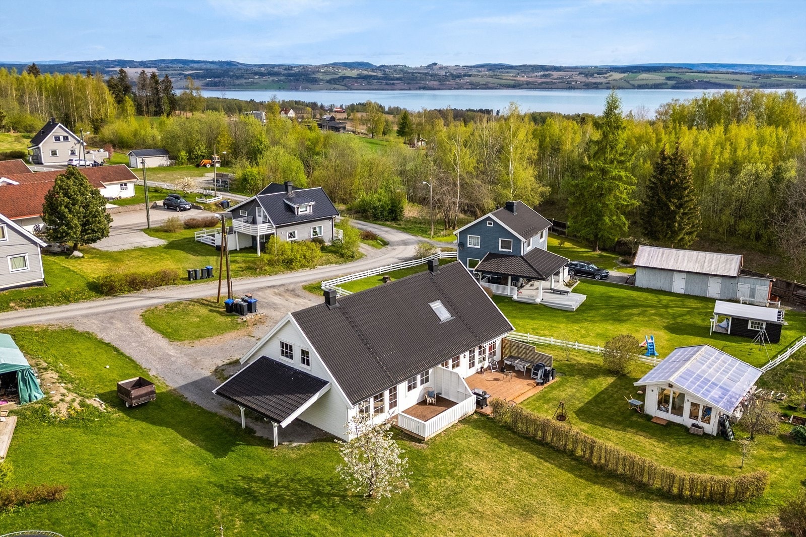 Dronebilde av eiendommen og nærliggende eiendommer, Mjøsa i bakkant. Galleribilde