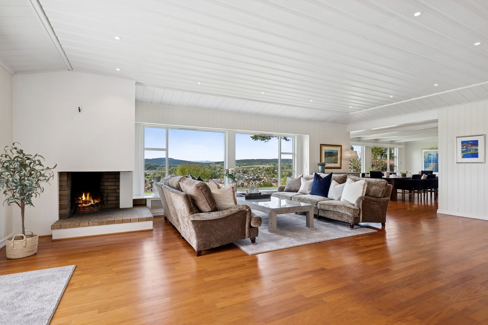 Storslått stue med imponerende takhøyde, store vindusflater og panoramautsikt over byen og det omkringliggende landskapet. Galleribilde