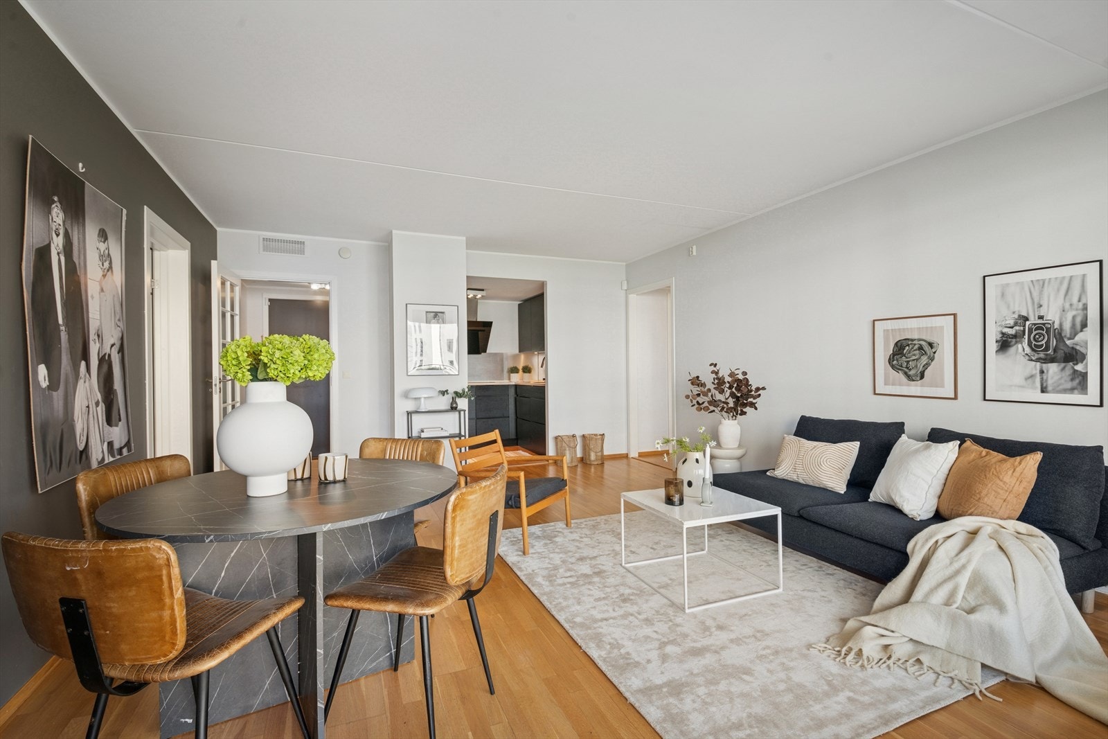 Boligen har et sosialt oppholdsrom med naturlige møbleringssoner. Galleribilde