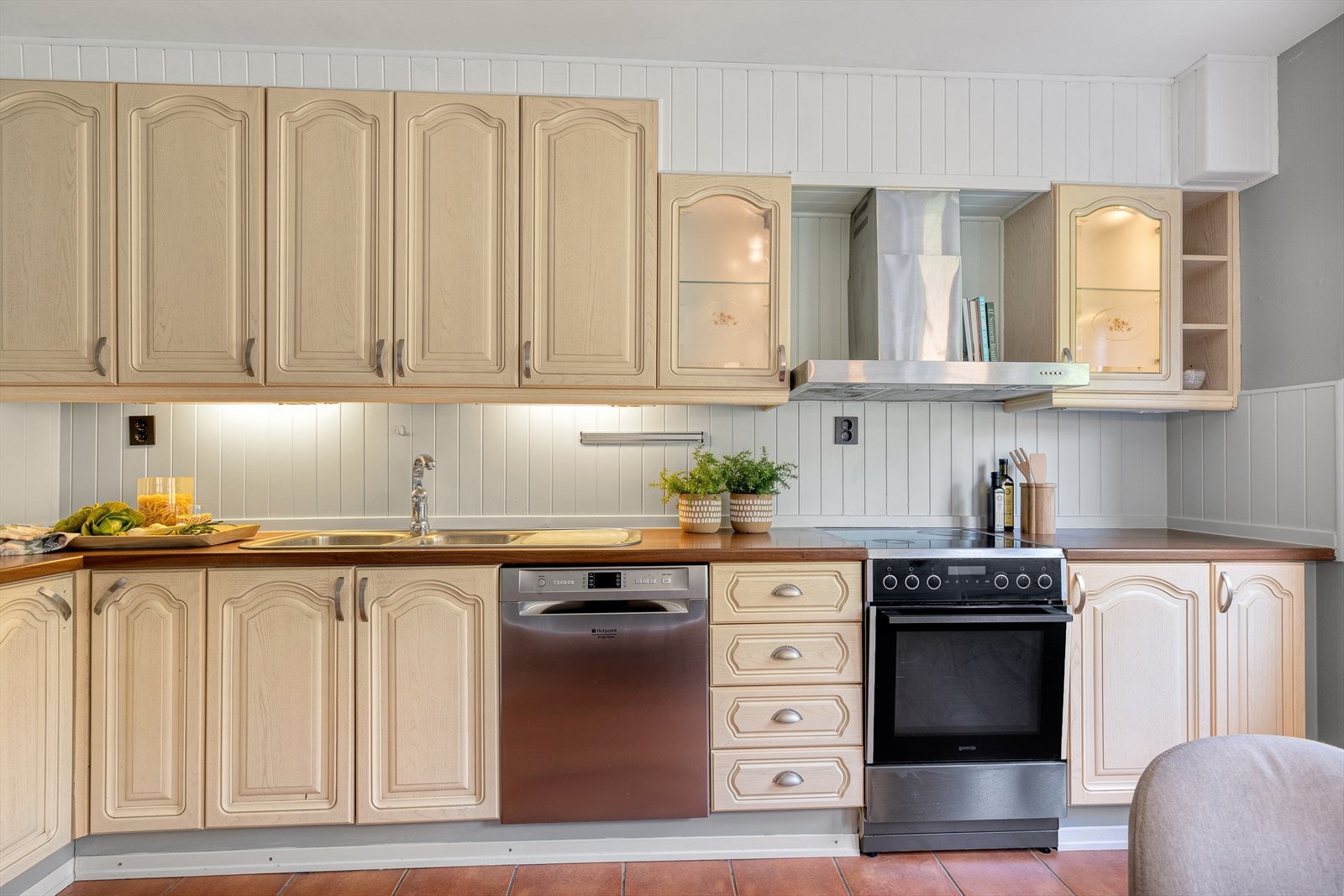 Kjøkkeninnredningen består av profilerte skapfronter, belysning og laminat benkeplate Galleribilde