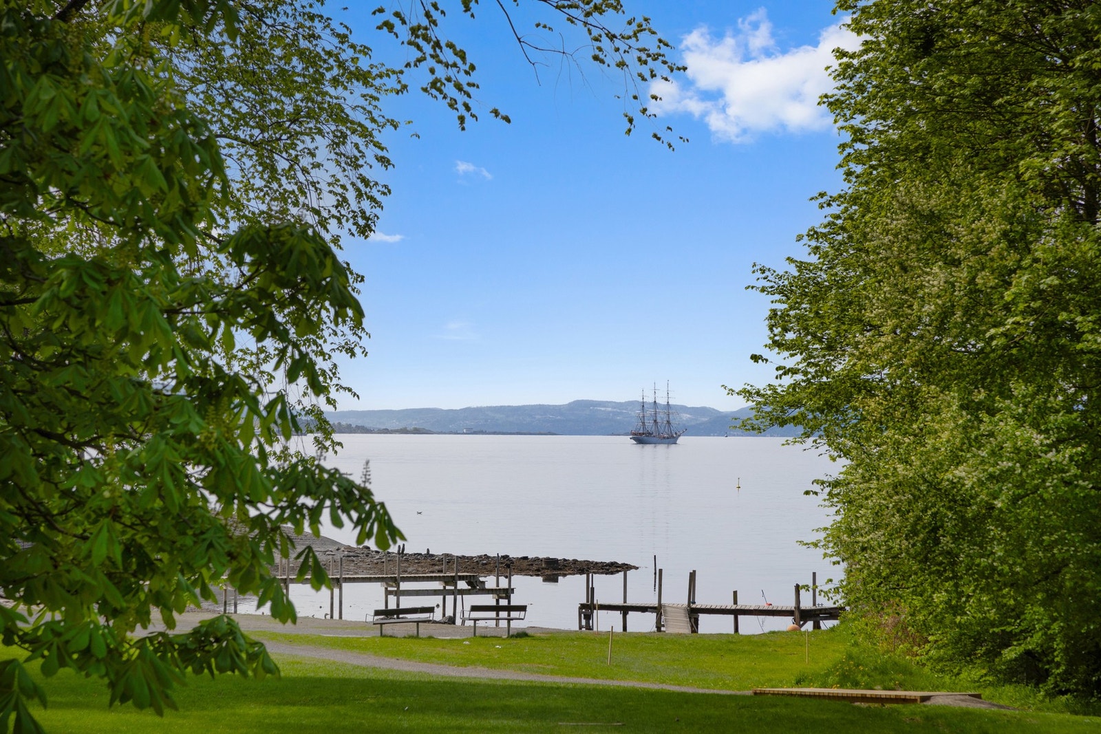 Rikelig med grønne lommer og benker der du kan nyte utsikten over fjorden. Galleribilde