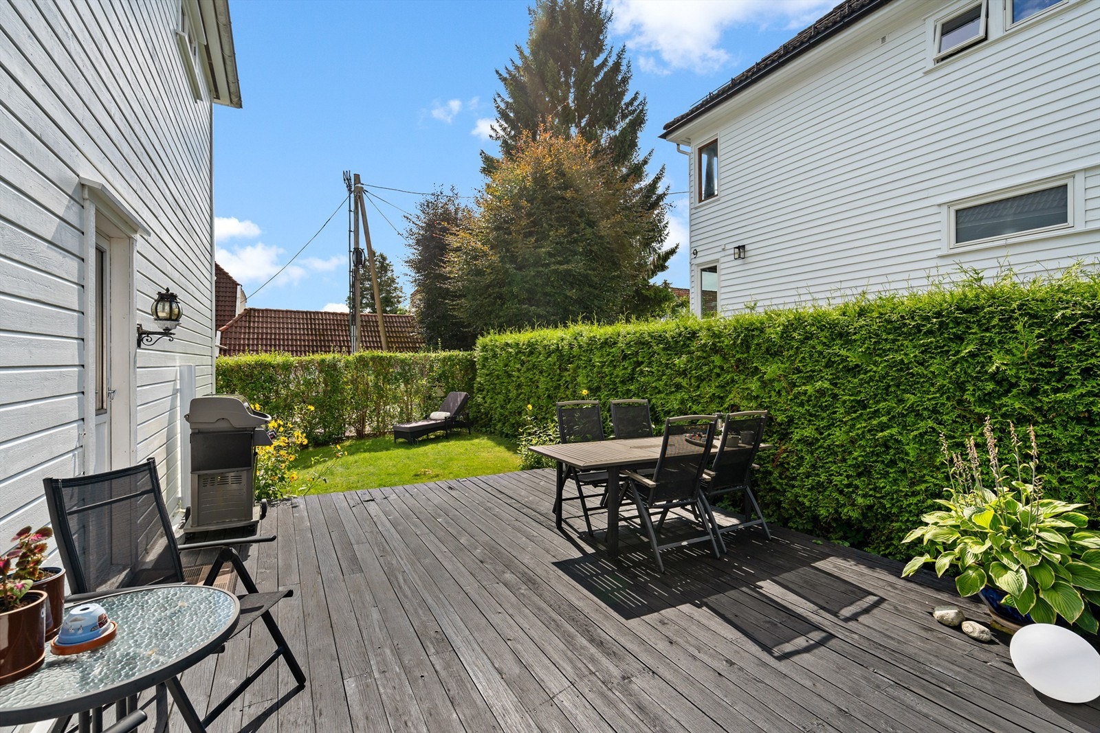 Lun og solrik uteplass med plass til sittegrupper og grill Galleribilde