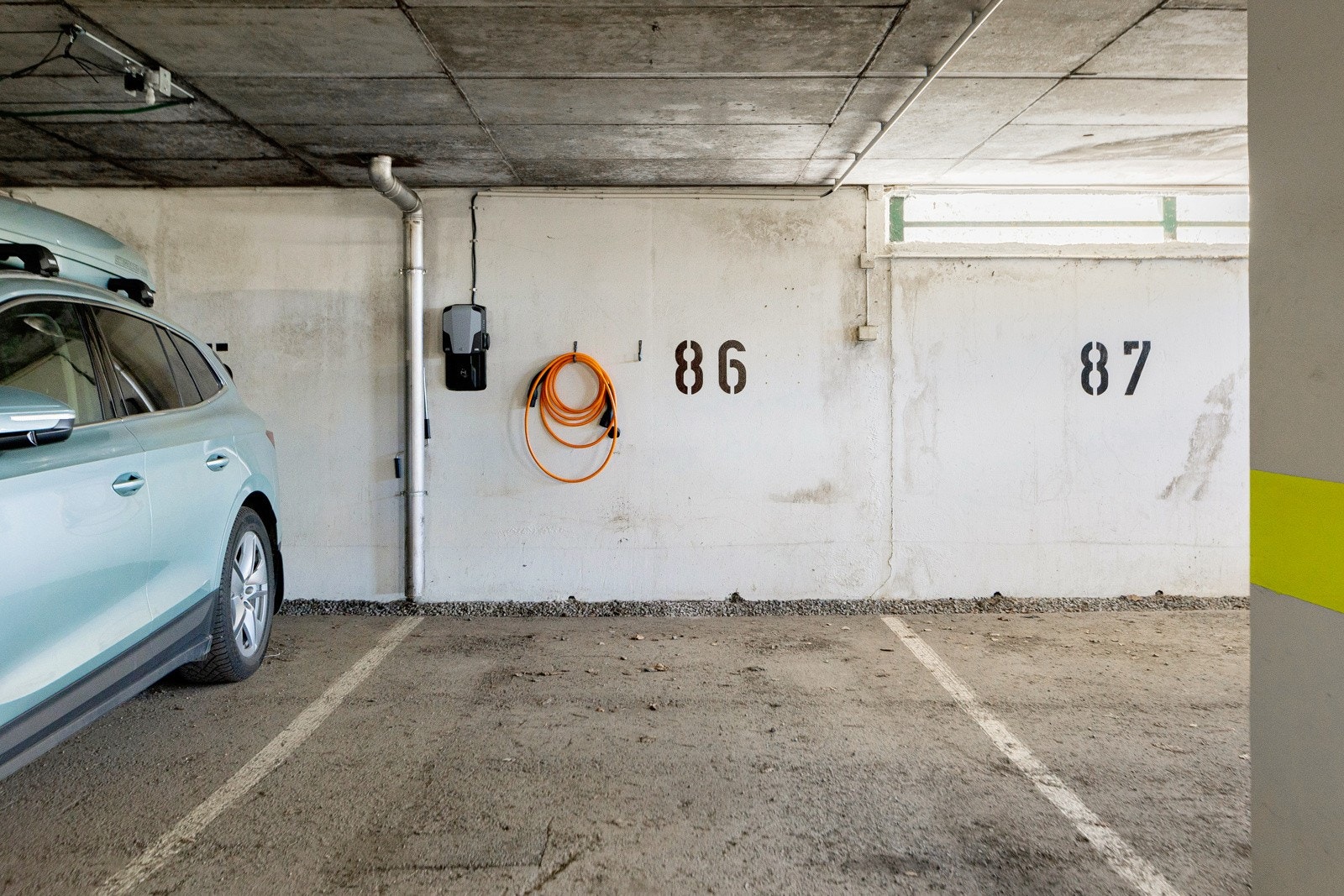 Parkeringsplass med elbillader i felles lukket garasjeanlegg Galleribilde