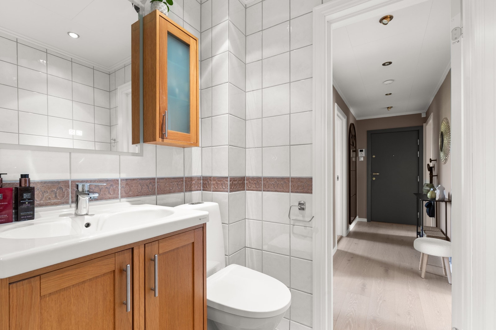 Innredningen består av vegghengt servantskap med profilerte fronter og nedsenket servant. Nytt speil med belysning fra 2025. Galleribilde