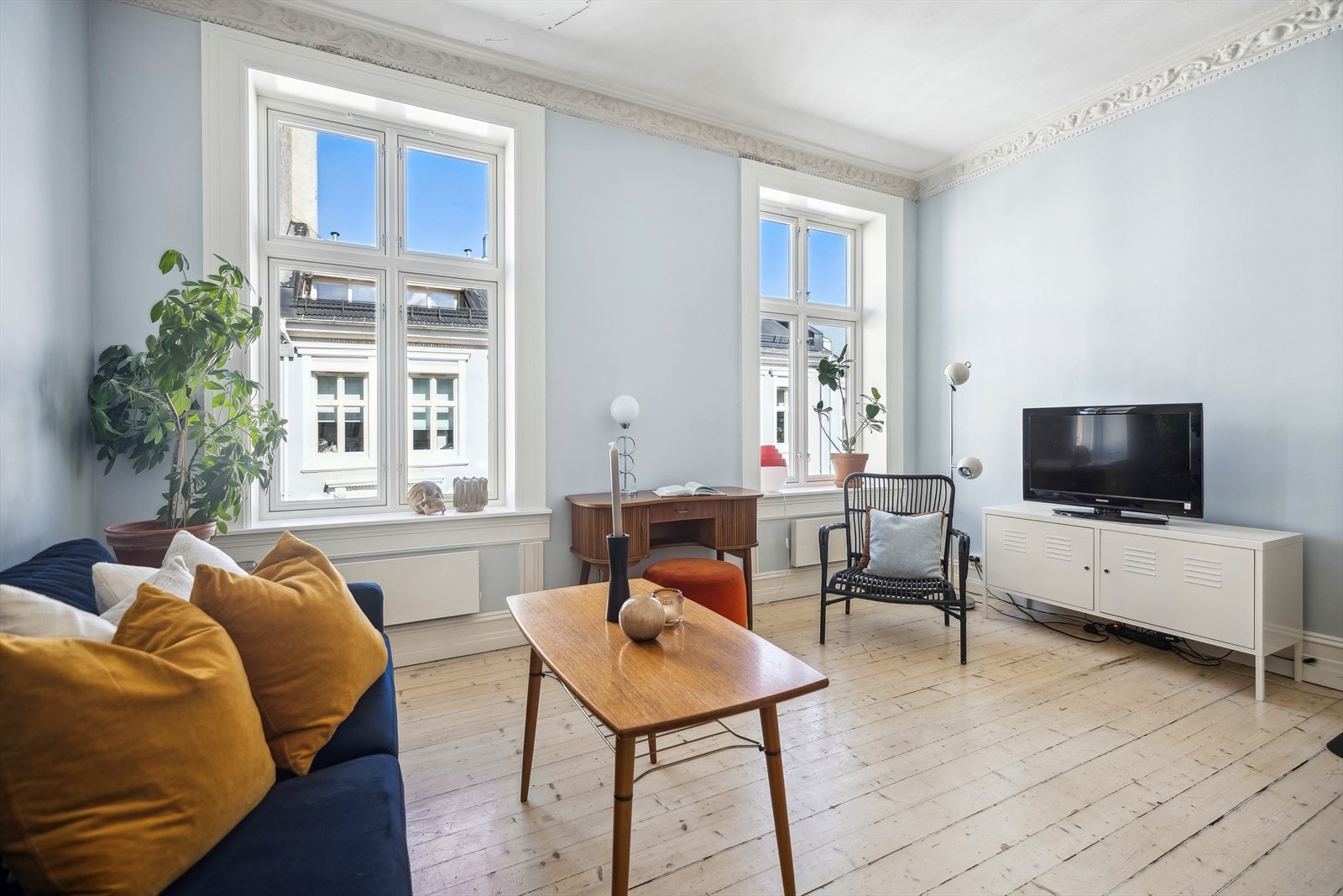 Leiligheten ligger høyt og fritt og store vinduer gir mye lys inn i stuen Galleribilde