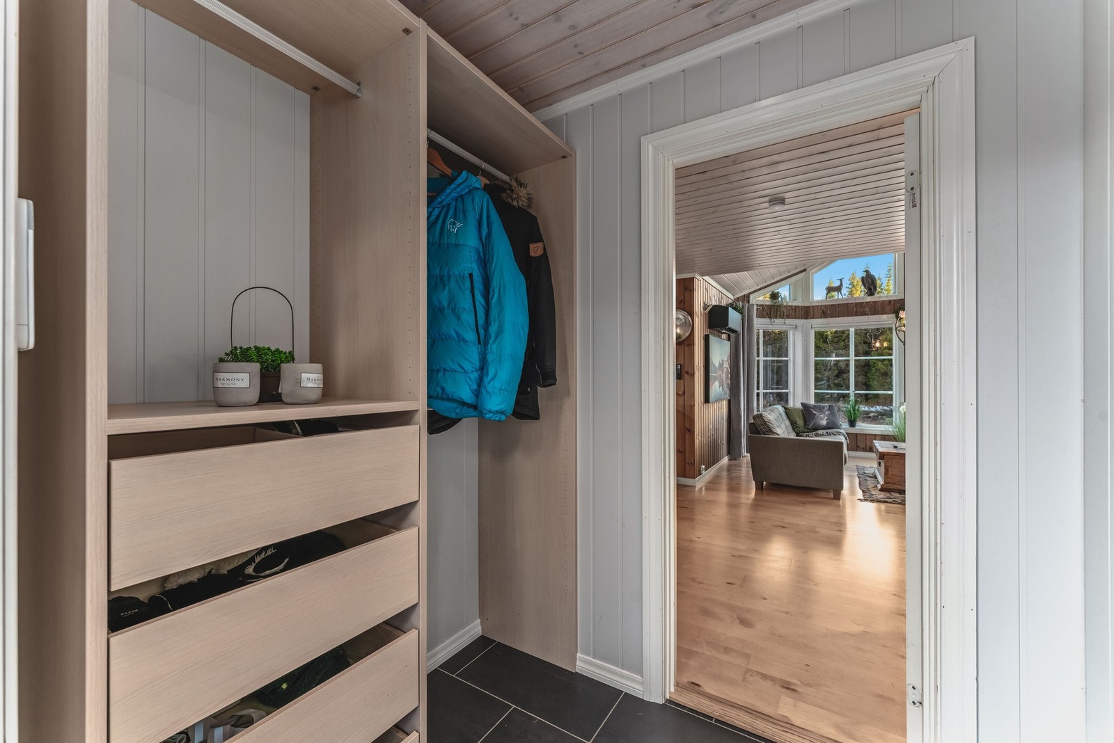 Lys og praktisk entré med garderobeløsning, skuffer og heng, samt Verisure alarmsystem og kodelås for trygg og enkel adkomst. Galleribilde