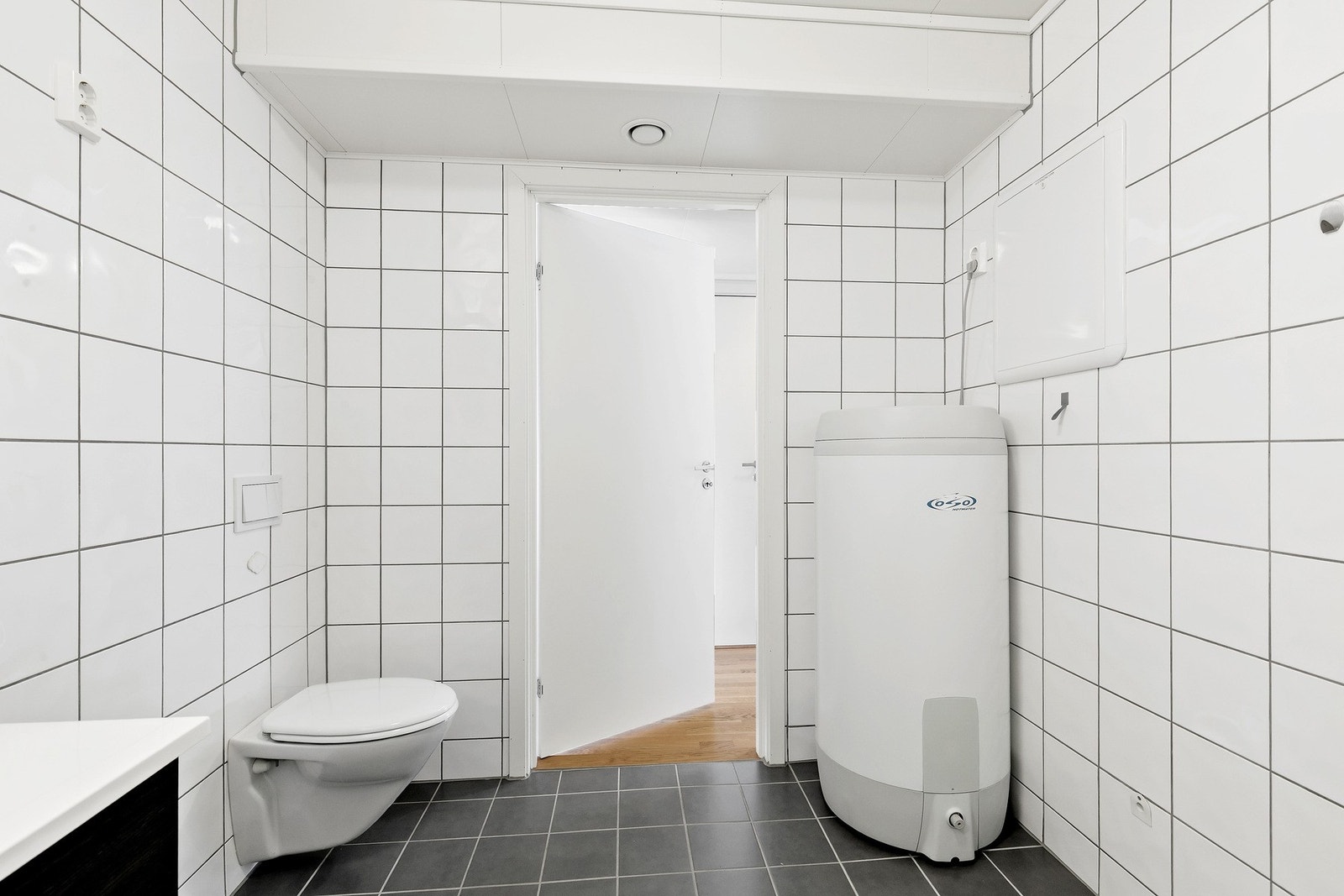 Badet er utstyrt med bereder, dusjkabinett, servantskap, veggmontert wc, rørfordelingsskap og mekanisk avtrekk. Galleribilde