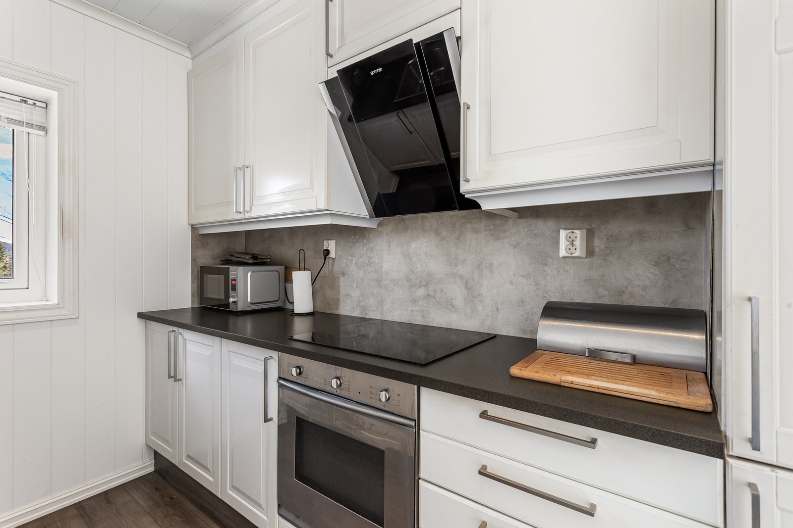 Flisimiterende plater på vegg over benkeplater av laminat Galleribilde