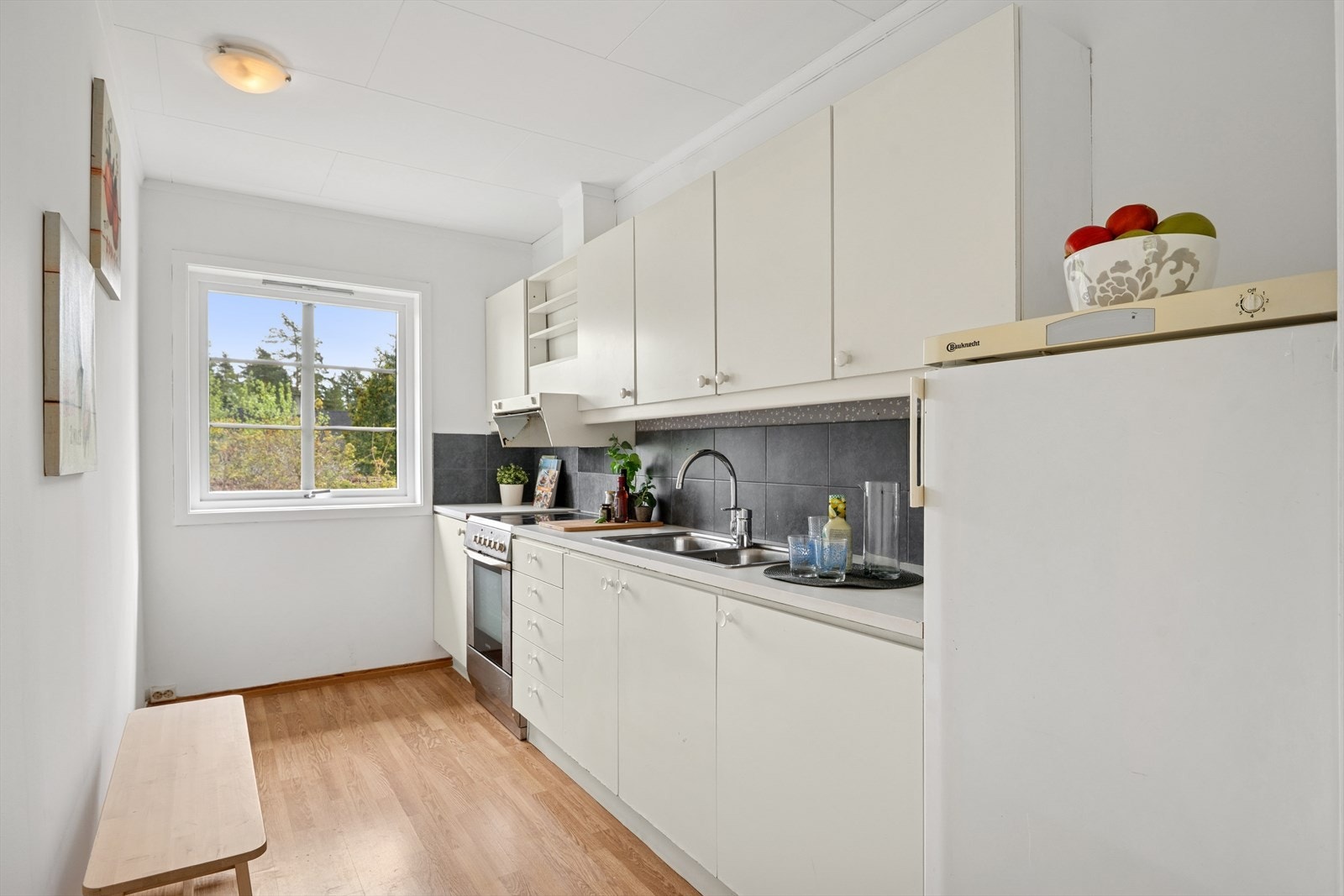 Kjøkkenet ligger i delvis åpning til stuen og har behov for modernisering. Galleribilde