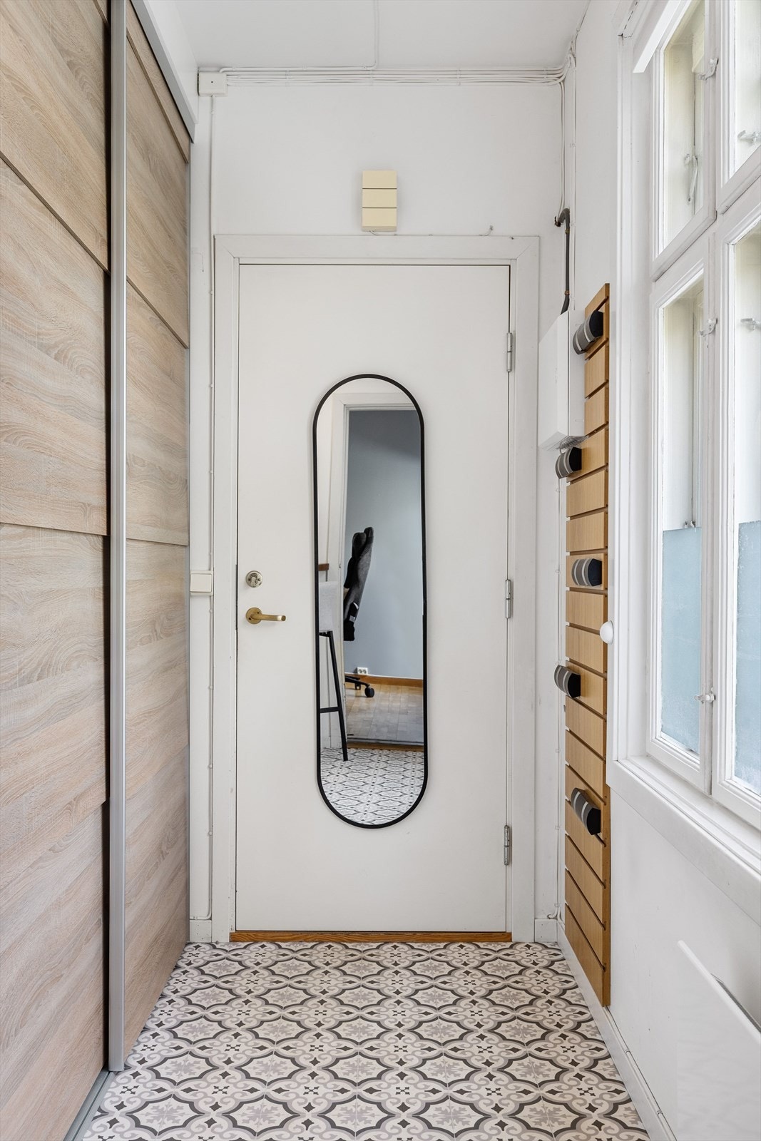 Vi beveger oss inn i leiligheten. Lys entré med plassbygd garderobeløsning. Galleribilde