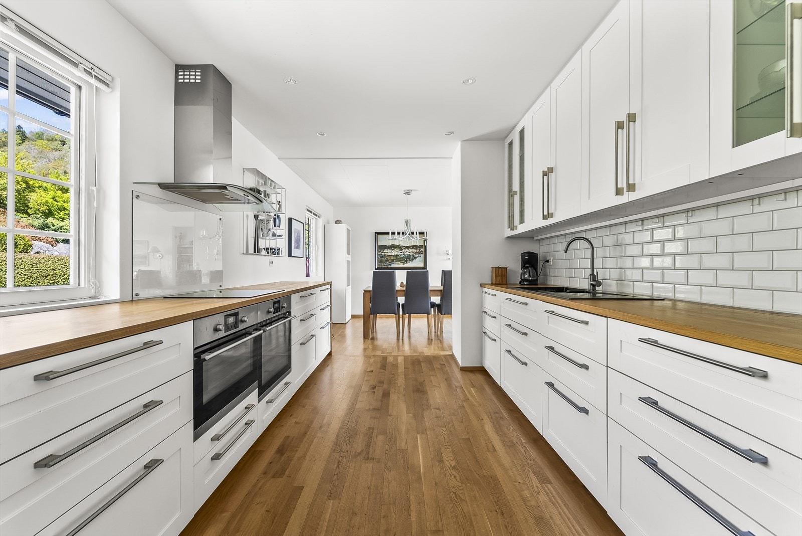 Lys og moderne kjøkkenløsning med god skapplass og stilrent design. Galleribilde